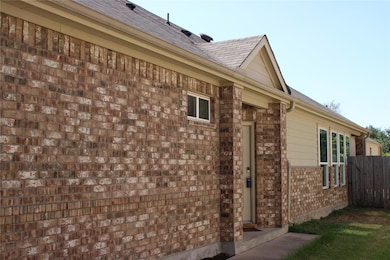 View of property exterior featuring brick siding 