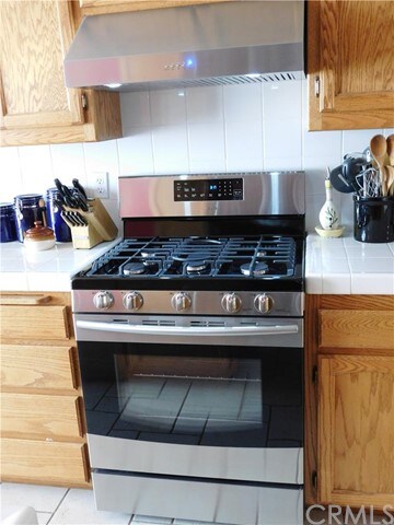 Brand new propane stove and hood.