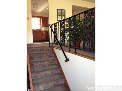 The opening at the top of the stairs is the kitche
