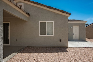 Rear view of house featuring stucco siding and a p