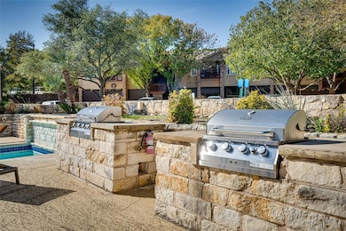 View of patio featuring area for grilling and a swimming pool