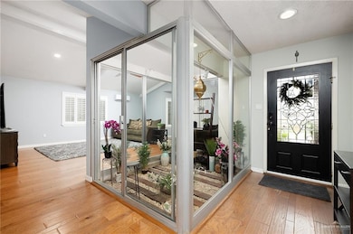 Foyer entrance featuring light wood-type flooring, recessed lighting, and a wall mounted AC