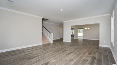 Unfurnished room with ornamental molding, dark har
