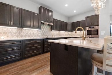 Kitchen with a breakfast bar, light wood-style fl