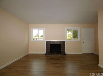 Another View of Living Room.  Double Pane Windows.  Fireplace.  Wood Laminate.