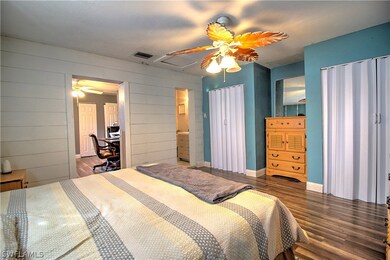 Large master bedroom with separate his/hers closets... and new laminate flooring!