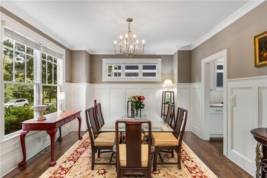 Formal dining room with wainscoting, crown molding