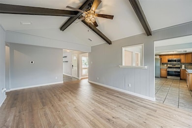 Unfurnished living room featuring a ceiling fan a