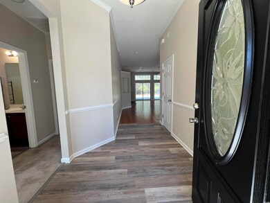 Foyer entrance featuring baseboards, crown molding