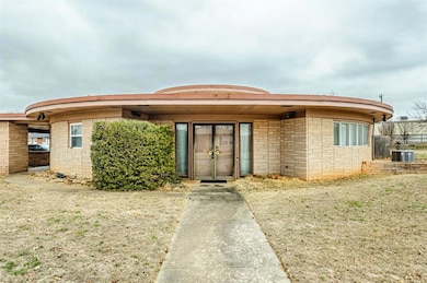 View of front of home featuring stone siding and cooling unit
