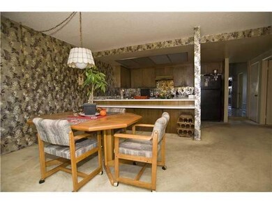 Dining area and or family with access from slider to backyard. Fireplace is to the right.