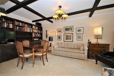 Family room with beamed ceiling and built ins.