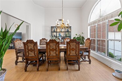 Dining room featuring wood finished floors, a chan