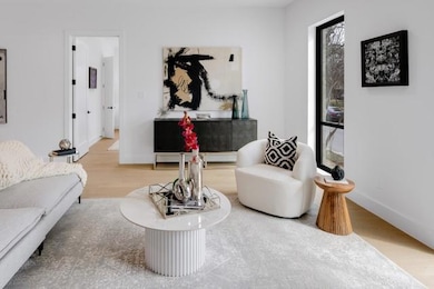 Living area with baseboards and wood finished floo
