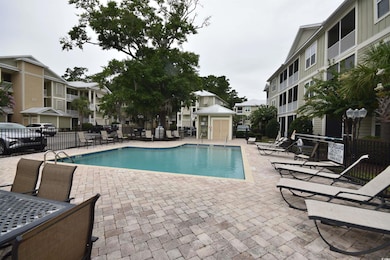 Community pool with a patio area and a residential view