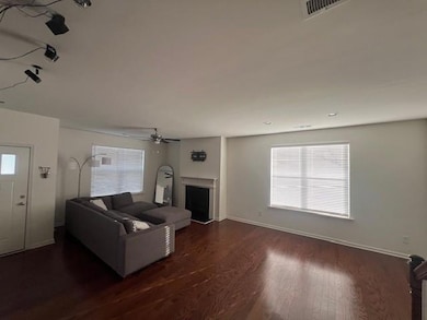 Unfurnished living room featuring dark hardwood / 