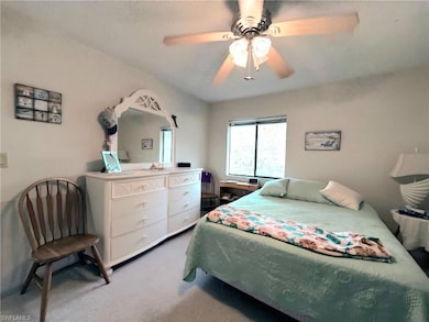 Carpeted bedroom featuring a ceiling fan