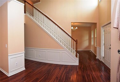 Grand Two Story Entry with Wainscoting and open to Dining Room and Living Room. 