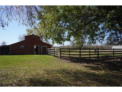 Exterior Front. Stable + corral and three fenced p