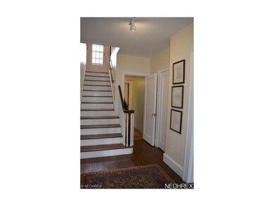 Open foyer with wood floors which opens to the liv