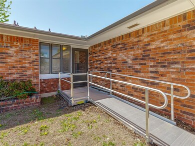 View of exterior entry featuring brick siding