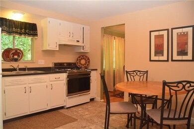 Updated kitchen with white cabinets, tile floor an