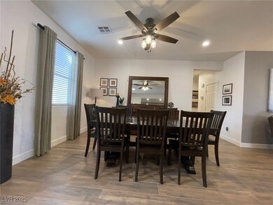 Dining area with a ceiling fan, baseboards, recess
