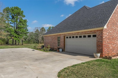 View of home's exterior with brick siding, drivewa