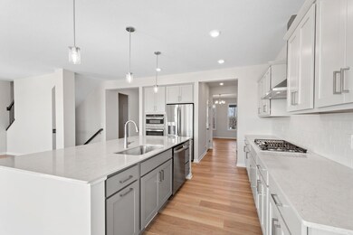 This stunning kitchen combines style and functionality.  Extensive durable quartz counter space perfect for meal prepping.