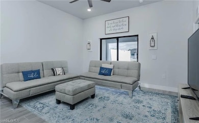 Living area featuring a ceiling fan, recessed ligh