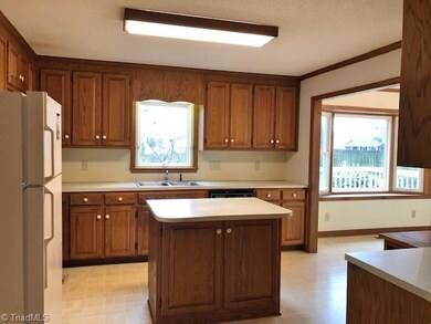 Bright Kitchen with tons of cabinet storage. Spacious pantry. Built-in Desk area with shelving. Island provides a great workspace!