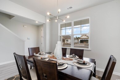 Dining area with a chandelier and light wood-style floors