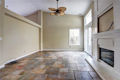 Unfurnished living room featuring a ceiling fan, h