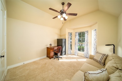 Front bedroom with bay window and ceiling fan