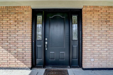 Primary second floor entry door is metal with glas
