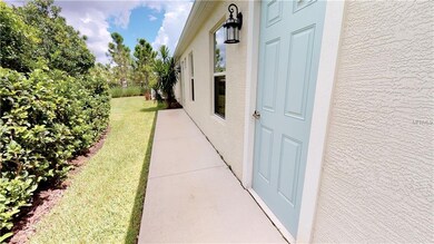 Walkway to garage and entry door to home