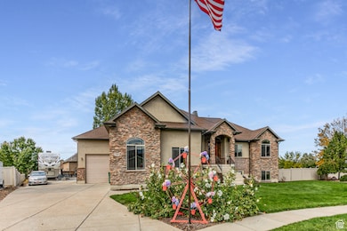 View of front of property with stone siding, stucco siding, concrete driveway, and a garage