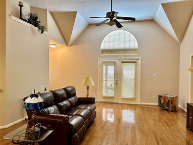 The double French doors open to a serene, shaded p