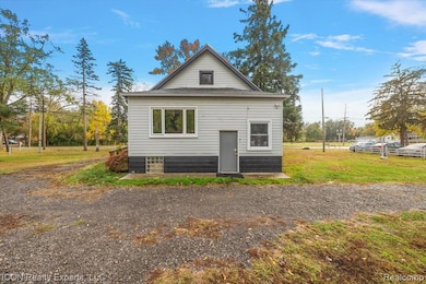 Rear view of house featuring a yard