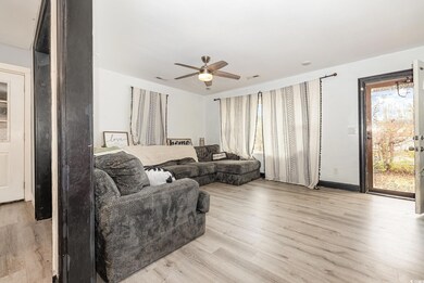 Living room featuring ceiling fan and light hardwo