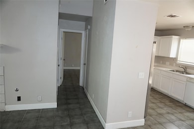Corridor featuring dark tile patterned floors
