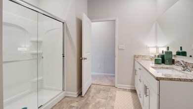 Bathroom featuring vanity and an enclosed shower