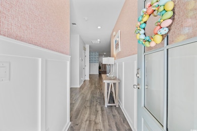 Corridor with visible vents and wood finished floo