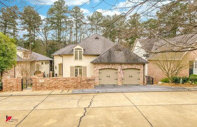 French provincial home with a garage, driveway, ro