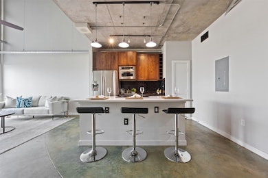 The open-concept kitchen features wood cabinetry,