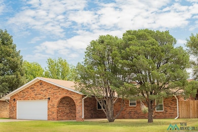 View of front of home with an attached garage and brick siding