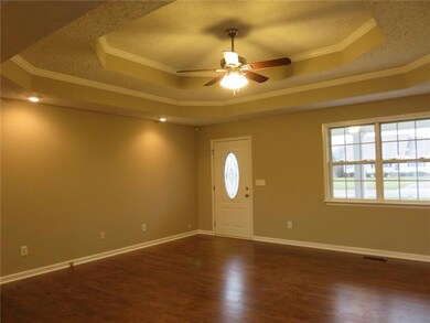 Living Room with new flooring, fresh paint, new light fixture and double trey ceilings
