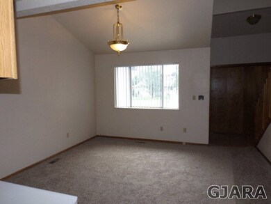 Living Room is light-bright with vaulted ceilings,