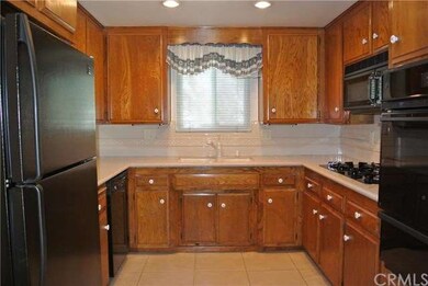 Quartz countertops and tile flooring. The applianc
