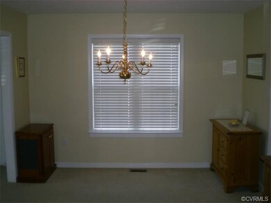 Dining room features a chandelier and double windo